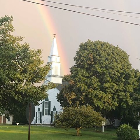 a rainbow over the church